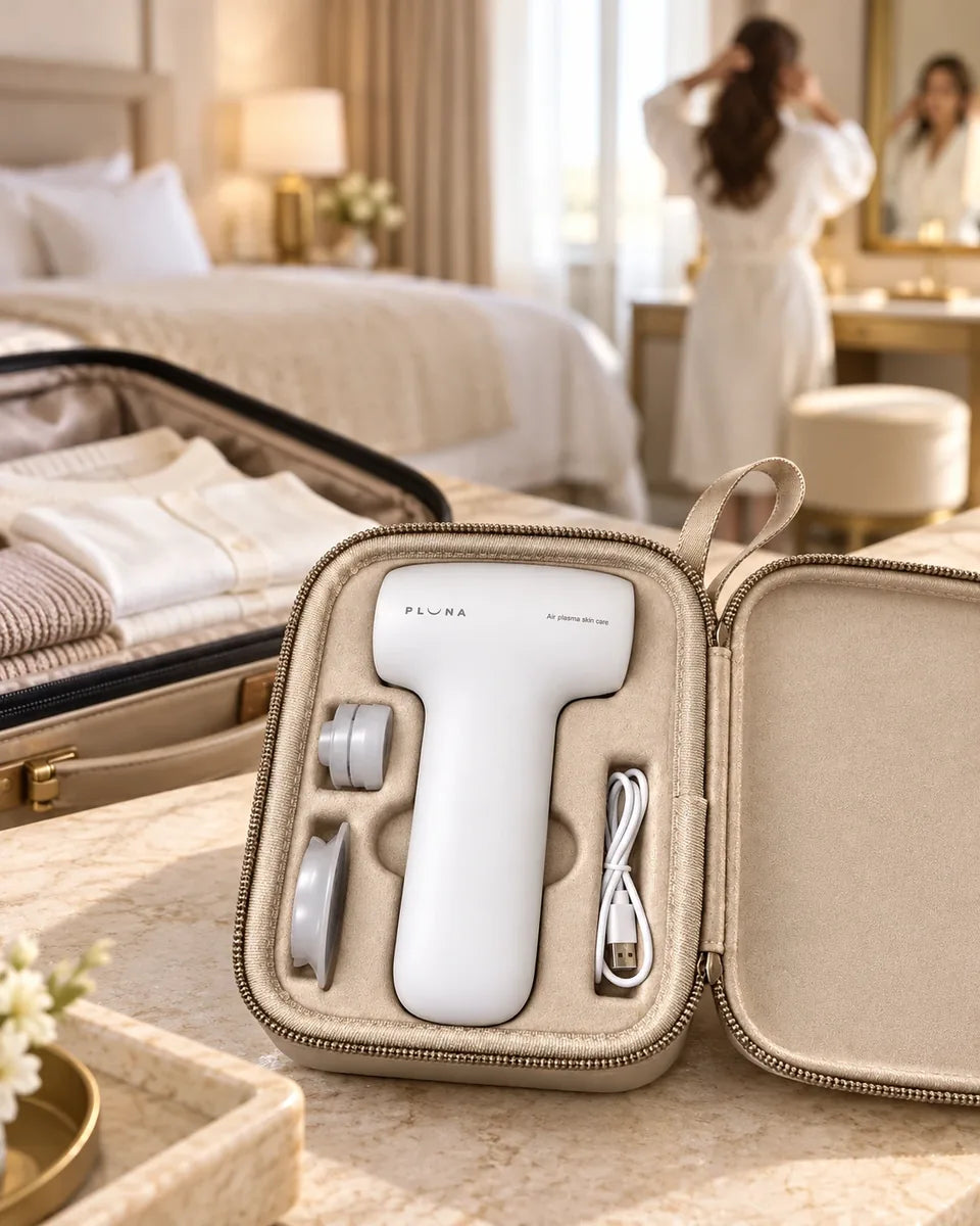 The PLUNA Travel Case open on a vanity beside a packed suitcase