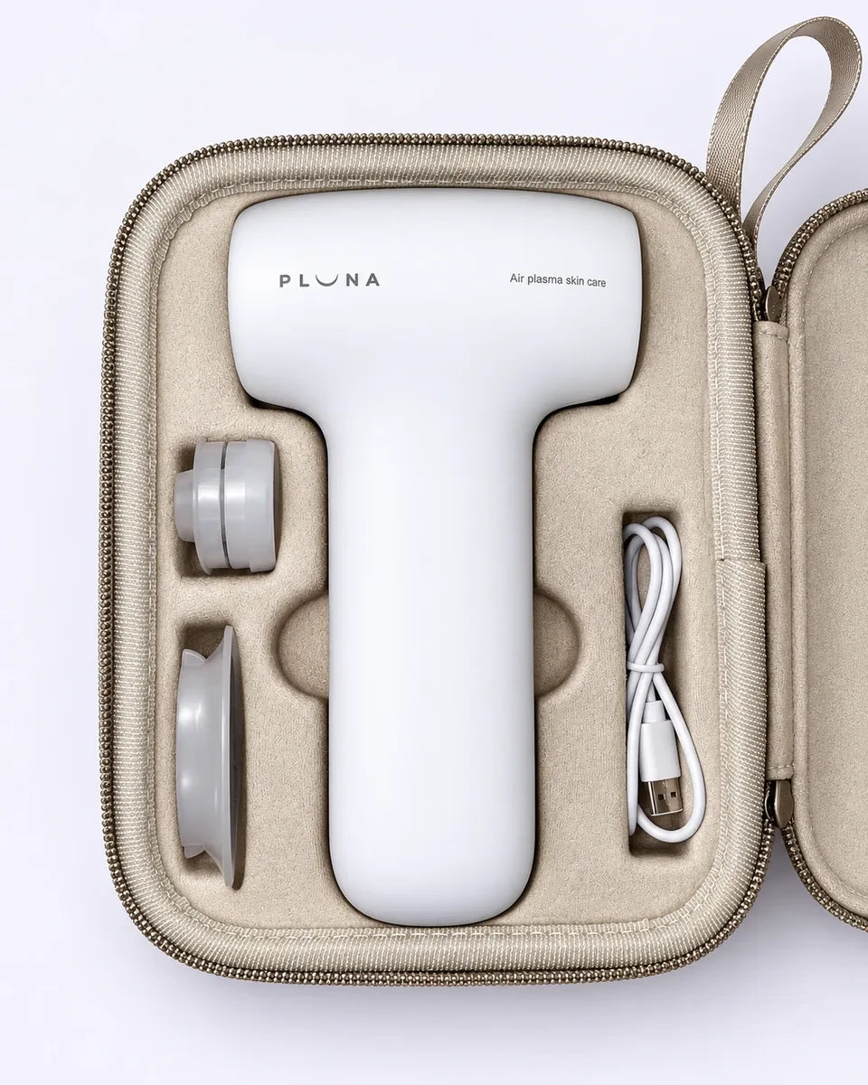 The PLUNA Travel Case open, holding the device, two tips and the USB-C cable